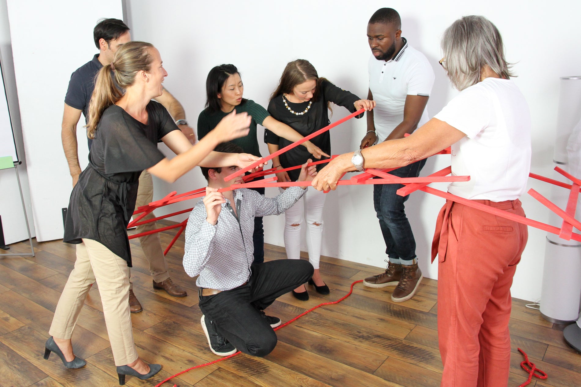 Adults use Leanardo's Bridge to practice working together to overcome obstacles and bridge divides.