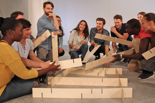 Employees solve a construction puzzle with Metalog StackMan, a collaboration game