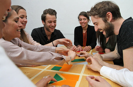 A small work team has fun playing Metalog Team²a hands on team building puzzle game